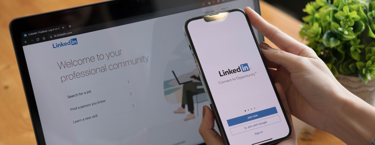 LinkedIn website pulled up on smartphone and laptop