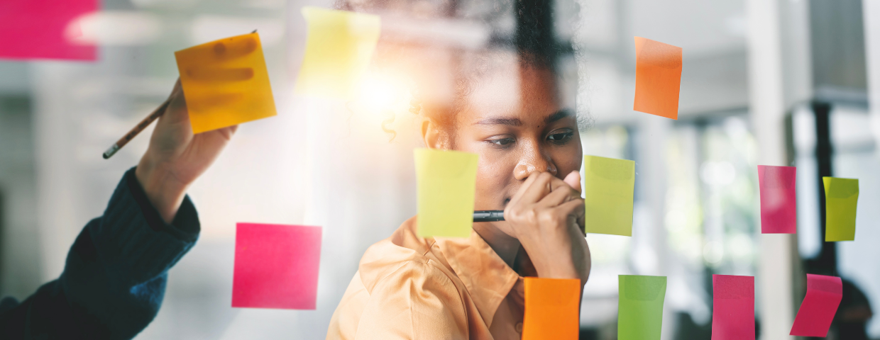 Woman writing on post its