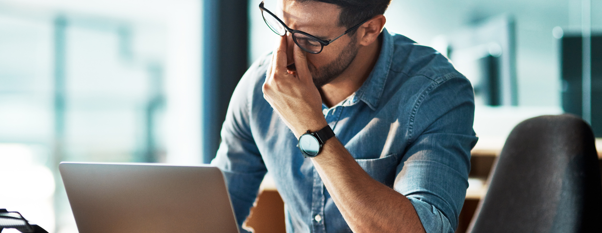 man tired in front of computer