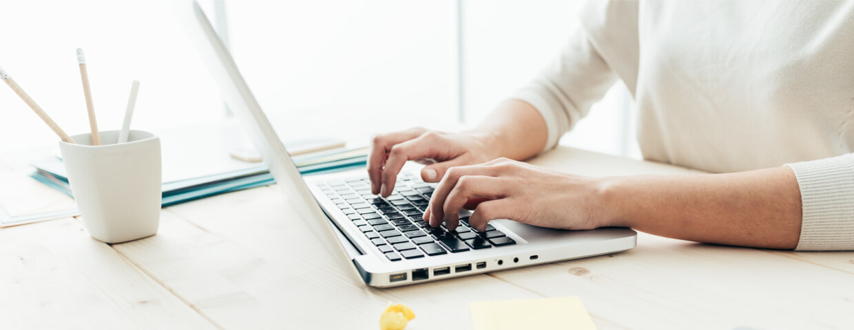 hands typing on a laptop